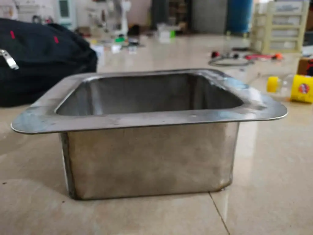 Steel test box of the enclosure's form, used to verify the flange seal under water before it went on the vehicle.